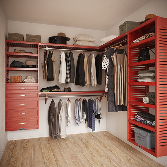 Red Mahogany L Shaped walk in closet organizer with 5 drawers,  clothes and hanging in a room.