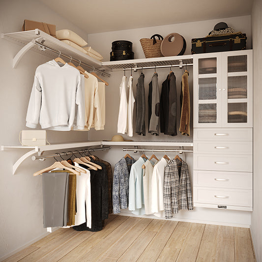 White L Shaped walk in closet organizer with 5 drawers and doors,  clothes and hanging in a primary bedroom closet.