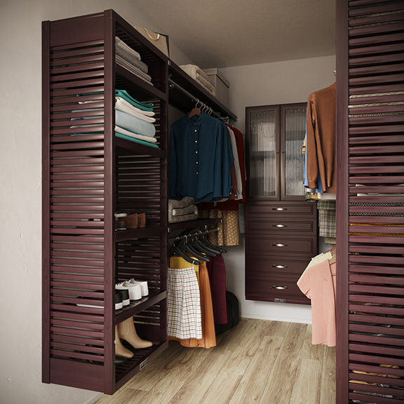 Espresso U shaped  closet organizer with doors, drawers, clothes and shelves in a room.