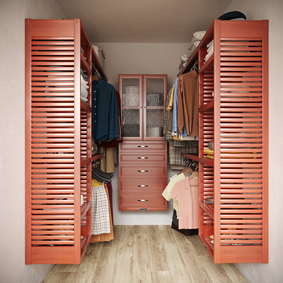 Red mahogany U shaped walk-in closet with shelves, drawers ,doors and clothes on hangers