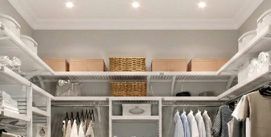 Organized closet with shelves, clothes, and storage baskets.