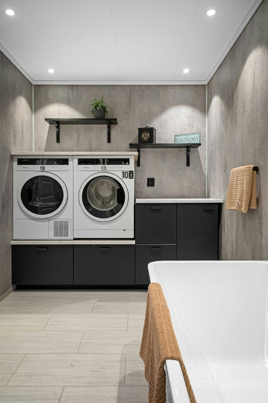 Organized laundry room with washer, dryer, and storage shelves