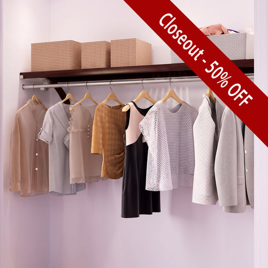 A solid wood closet shelf holding three beige storage boxes and a metal hanging rod with multiple light wood hangers holding assorted women's tops and a dress.