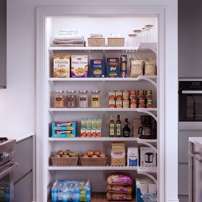 A small L shaped walk-in pantry with 5 levels of white solid wood shelving filled with grocery items.