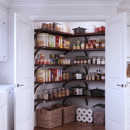 A fully stocked L shaped walk-in pantry with 5 tiers of espresso solid wood shelves filled with kitchen appliances and  grocery foods.
