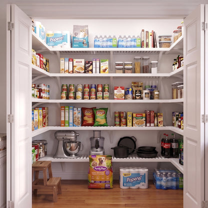 A well-organized standard walk-in pantry with 5 white finished solid wood shelves stocked with various grocery items.