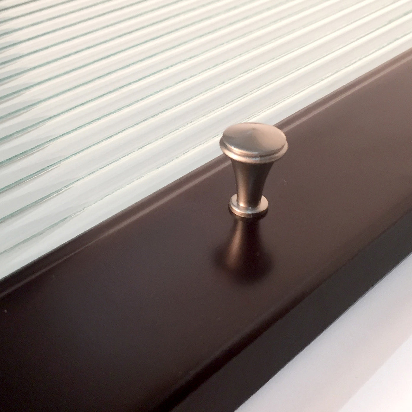 closeup of glass door handle espresso