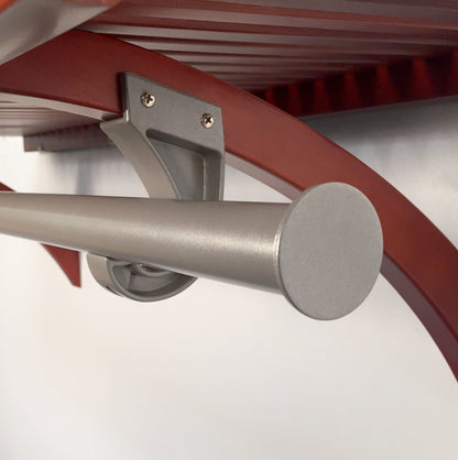Metal garment bar attached to a solid wood shelf and white wall