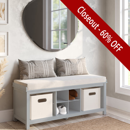 Storage bench with cushions and open cubbies in a room with a mirror and window.
