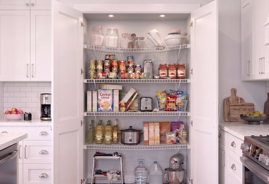 A before image of an open white pantry cabinet with sagging wire shelves with tipping groceries.