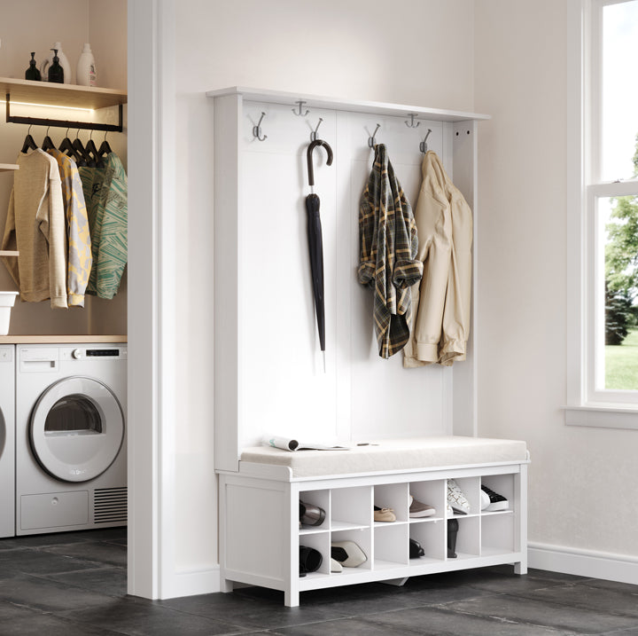 White coat rack with hooks and storage bench in a laundry room.