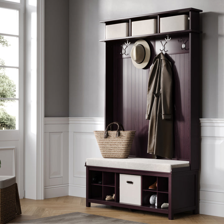 Entryway with a dark wood hall tree with storage compartments, hooks, and a seat.