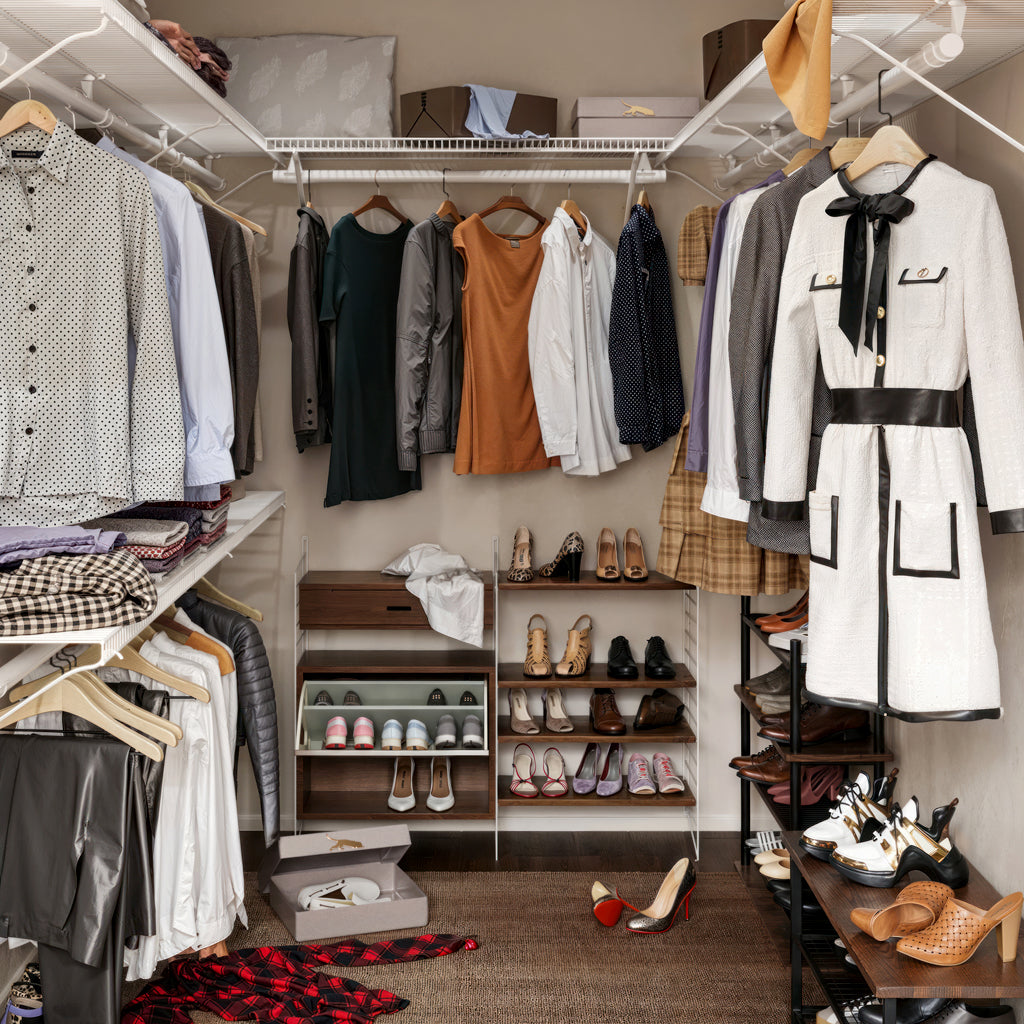 before image of a closet with clothes, shoes, and bags organized on shelves and racks.